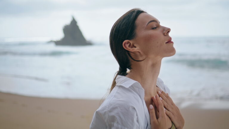 woman-enjoy-breeze-standing-near-waves